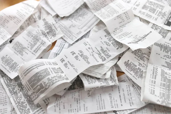 A messy pile of paper receipts